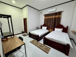 Ένα ή περισσότερα κρεβάτια σε δωμάτιο στο Lalisa Guesthouse