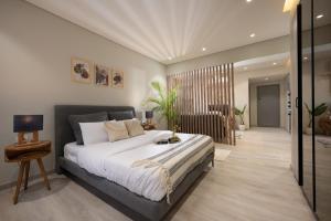 a bedroom with a large bed and a living room at Degla by Spacey # 39 - Studio in Maadi in Cairo