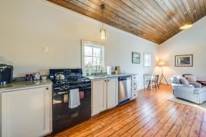 a kitchen with a stove and a wooden ceiling at Countryside Barndominium in Virginia with Patio in Zion Crossroads +23 photos