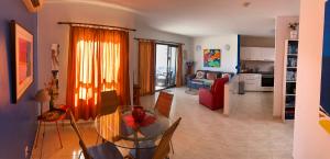 a dining room and living room with a glass table at Villa Primera in Playa Blanca