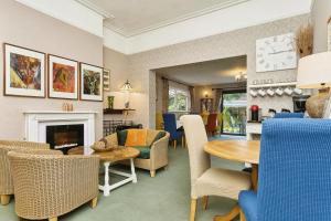 a living room with a table and chairs at Foxhills of Shanklin in Shanklin