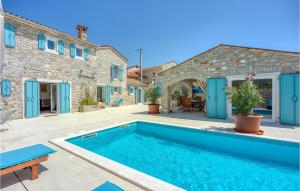 a villa with a swimming pool and a house at Lovely Home In Selina in Selina +27 photos