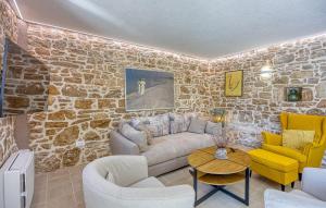 a living room with a stone wall at Lovely Home In Selina in Selina