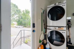 a washer and dryer sitting next to a door at Cozy 2BR1BA apt in SilverSpeing in Silver Spring