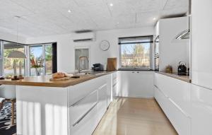 a kitchen with white cabinets and a counter top at Beautiful Home In Glesborg in Glesborg