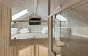 a room with two beds in it with a window at Gorgeous Home In Glesborg With Sauna in Glesborg +17 photos