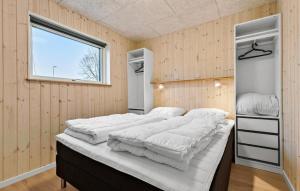a bedroom with a large bed with white sheets at Gorgeous Home In Glesborg With Sauna in Glesborg