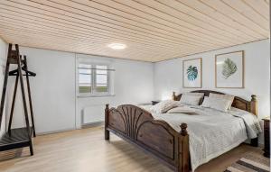 a bedroom with a bed and a wooden ceiling at 2 Bedroom Beautiful Home In Bogense in Bogense +12 photos