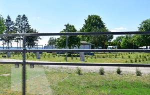 a fence with a view of a field at Nice Home In Nowe Warpno in Nowe Warpno