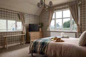 een slaapkamer met een bed met een dienblad met eten erop bij Broadway Country Chic Cottage in Broadway