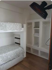 a bedroom with a bed and a ceiling fan at Casa Amar in Barra dos Coqueiros