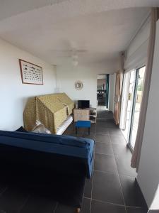a living room with a bed and a couch at tite Caz a nou in Saint-Paul