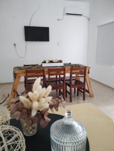 a living room with a table with a vase of flowers at Casa Poetas in Villa Nueva