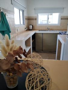 a kitchen with two baskets on a table with a sink at Casa Poetas in Villa Nueva