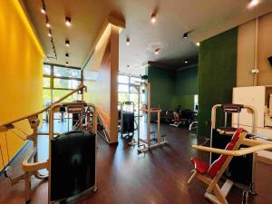 a gym with several treadmills and equipment in a room at Sea View Cozy 2BR Green Haven -Permas Masai CIQ -7 to 9pax in Masai