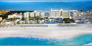 an aerial view of a beach with buildings and the ocean at Luxury Ocean Front with Activities & Entertainment in Cancún
