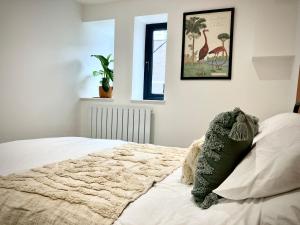 a bedroom with a bed and a picture on the wall at City Centre Garden Apartment in Exeter