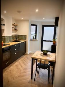 a kitchen with a table and a table and chairs at City Centre Garden Apartment in Exeter