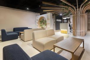 a waiting room with chairs and a table at Aparthotel Nou Vielha in Vielha
