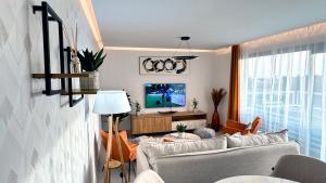 a living room with a couch and a tv at Luxury Golf Apartman in La Cala de Mijas Golf in Mijas