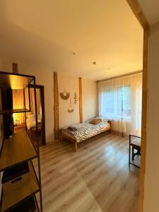 a bedroom with a bed in the corner of a room at visitDINAMO in Kandava