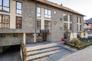 a brick building with stairs in front of it at Aparthotel Nou Vielha in Vielha
