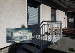 a sign on a staircase with a lighthouse sign on it at Seekiste in Schleswig