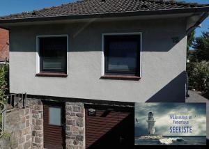 a house with a sign on the side of it at Seekiste in Schleswig