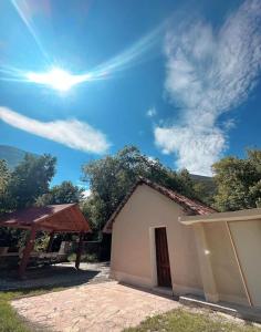a building with a picnic table and the sun in the sky at ESTANCIA CASA DE PIEDRA casa 2 in San Isidro