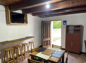 a dining room with a table and chairs and a kitchen at ESTANCIA CASA DE PIEDRA casa 2 in San Isidro