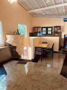 a kitchen and dining room with a table and chairs at Nautilus Cottage Unawatuna in Unawatuna