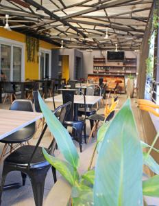 an empty restaurant with tables and chairs and plants at Terra Bella Hotel Boutique in San Salvador +12 photos