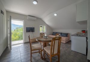 a kitchen and living room with a table and a couch at Private Viewpoint Apartments in Lipci