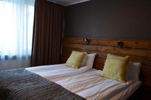 Postel nebo postele na pokoji v ubytování Hotel Falun