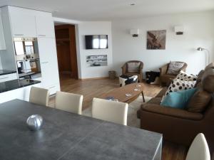 a living room with a table and a couch at Chalet Mittaghorn in Adelboden