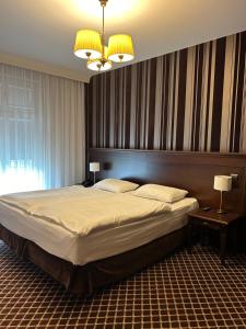 Posteľ alebo postele v izbe v ubytovaní Hotel Wileński