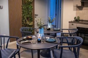 two tables and chairs with food and flowers on them at Dimora San Lorenzo in Taranto