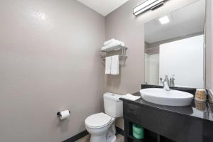 a bathroom with a sink and a toilet and a mirror at Studio 6 Extended Stay - Tucker, GA - Atlanta Northlake in Tucker