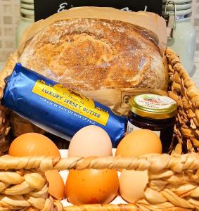 a basket of bread and eggs and a loaf of bread at THE OLD WASH KITCHEN - Charming Character Cottage in Holmfirth, Yorkshire in Holmfirth +18 photos