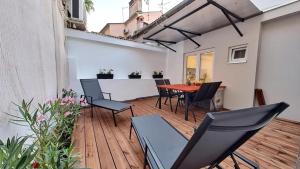 a patio with a table and chairs on a wooden deck at Old Tower Center Apartment 2 in Pula