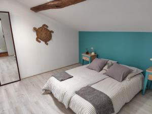 a bedroom with a bed with a teddy bear on the wall at Ohikoa in Saint-Étienne-dʼOrthe