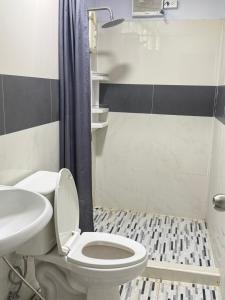 a bathroom with a toilet and a sink and a shower at บ้านเชิงเขาโฮมสเตย์ บ้านบนเขา in Ban Mai