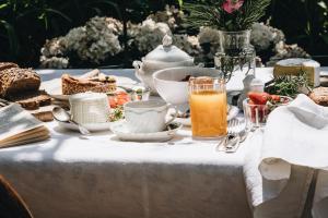 a table with a breakfast of food and orange juice at La Corte di San Rocco in Trento