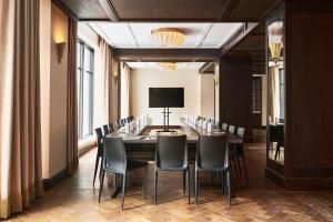 a conference room with a long table and chairs at Fidelity Hotel in Cleveland