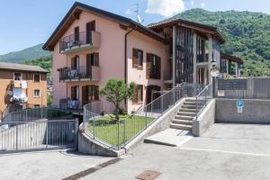 a building with a staircase in front of it at Modern apartment with balcony-garage-and pool in Bellano