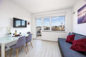 TV a/nebo společenská místnost v ubytování Ancora Center Apartment