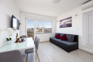 TV a/nebo společenská místnost v ubytování Ancora Center Apartment