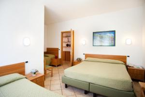 Postel nebo postele na pokoji v ubytování Hotel La Toscana