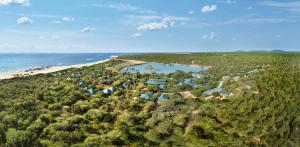 an aerial view of a beach and houses at Cinnamon Wild Yala in Yala +29 photos