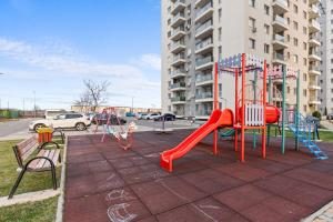 un parque infantil con un tobogán rojo en Studio in Dimri Resident Ghencea, en Bucarest